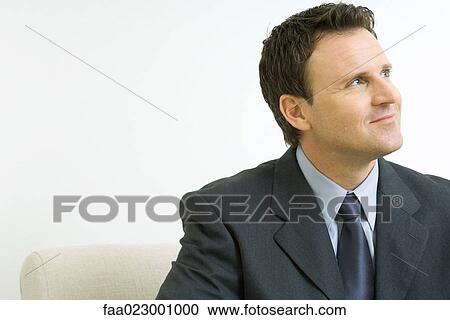 Businessman smiling, looking up, portrait View Large Photo Image Stock Image - Businessman smiling, looking up, portrait. Fotosearch