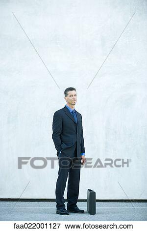 Businessman standing, looking at camera, full length portrait View Large Photo Image Stock Photo - Businessman standing, looking at camera, full length portrait. Fotosearch