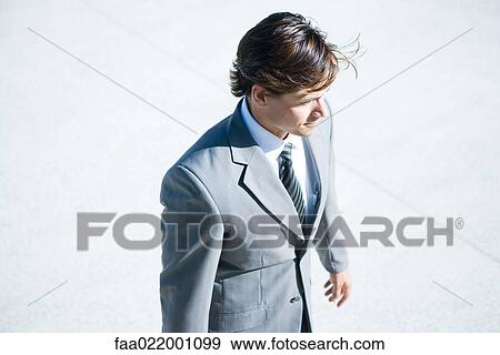 Businessman standing outdoors, waist up, high angle view View Large Photo Image Stock Photo - Businessman standing outdoors, waist up, high angle view. Fotosearch