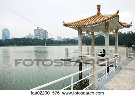 Stock Photograph - China, Guangdong province, gazebo on edge of water. Fotosearch