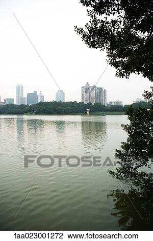Stock Image - China, Guangdong Province, Guangzhou, view of skyscrapers in distance. Fotosearch