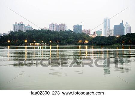 Stock Image - China, Guangdong Province, Guangzhou, view of skyscrapers in distance. Fotosearch