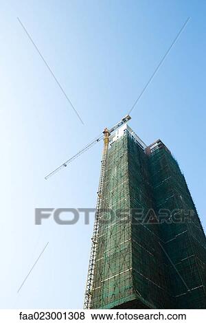 China, Guangdong Province, Guangzhou, high rise under construction View Large Photo Image Stock Photo - China, Guangdong Province, Guangzhou, high rise under construction. Fotosearch