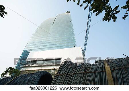 China, Guangdong Province, Guangzhou, skyscraper under construction and reels of cable, low angle view View Large Photo Image Stock Photograph - China, Guangdong Province, Guangzhou, skyscraper under construction and reels of cable, low angle view. Fotosearch