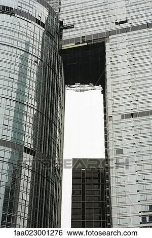 Stock Photograph - China, Guangdong Province, Guangzhou, window washers cleaning facade of skyscraper. Fotosearch
