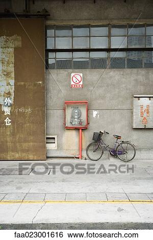China, Guangdong Province, Guangzhou, bicycle parked against wall View Large Photo Image Stock Photograph - China, Guangdong Province, Guangzhou, bicycle parked against wall. Fotosearch