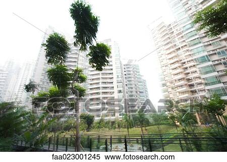 China, Guangdong Province, Guangzhou, high rise apartments and park, blurred motion View Large Photo Image Stock Photography - China, Guangdong Province, Guangzhou, high rise apartments and park, blurred motion. Fotosearch