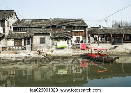 China, Guangdong Province, houses on edge of water, with boat View Large Photo Image Stock Image - China, Guangdong Province, houses on edge of water, with boat. Fotosearch