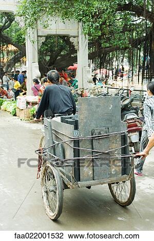 China, Guangdong province, man transporting goods to street market with rickshaw View Large Photo Image Stock Image - China, Guangdong province, man transporting goods to street market with rickshaw. Fotosearch