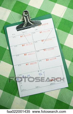 Stock Photography - Clipboard with bills in Chinese characters. Fotosearch