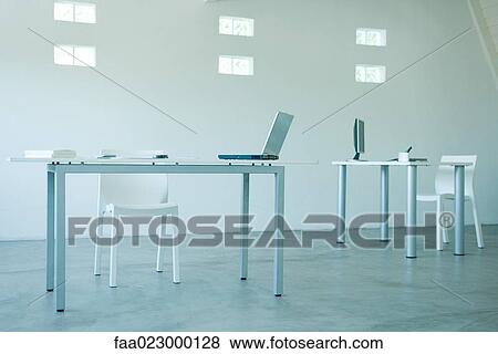 Computers on desks in office View Large Photo Image Stock Photo - Computers on desks in office. Fotosearch