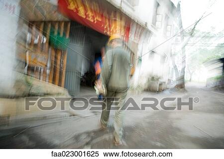 Construction worker walking away, blurred motion View Large Photo Image Stock Photography - Construction worker walking away, blurred motion. Fotosearch