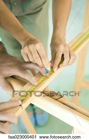 Couple measuring and marking piece of wood, close-up of hands View Large Photo Image Stock Image - Couple measuring and marking piece of wood, close-up of hands. Fotosearch