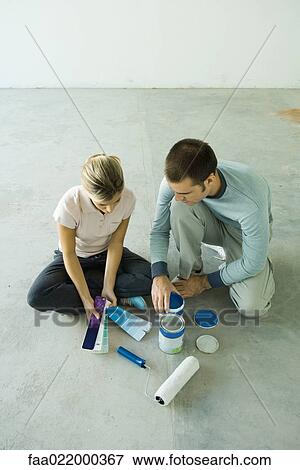 Couple sitting on floor looking at color swatches View Large Photo Image Stock Photo - Couple sitting on floor looking at color swatches. Fotosearch