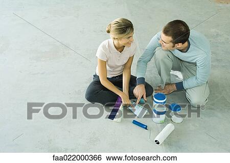 Couple sitting on floor looking at color swatches View Large Photo Image Stock Photograph - Couple sitting on floor looking at color swatches. Fotosearch
