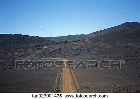 Stock Photography - Dirt path through arid landscape, Reunion. Fotosearch
