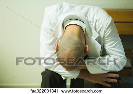 Doctor sitting with head down View Large Photo Image Stock Image - Doctor sitting with head down. Fotosearch