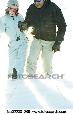 Father and daughter walking in snow together, holding hands, cropped view View Large Photo Image Stock Photo - Father and daughter walking in snow together, holding hands, cropped view. Fotosearch