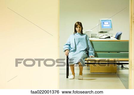 Female patient sitting in doctor's office, looking at camera, view through doorway View Large Photo Image Stock Photograph - Female patient sitting in doctor's office, looking at camera, view through doorway. Fotosearch