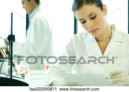 Stock Image - Female scientist working in lab. Fotosearch