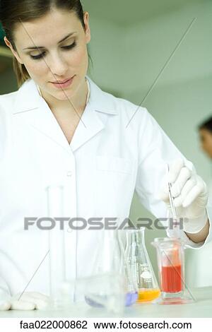 Female scientist working with various solutions in laboratory glassware View Large Photo Image Stock Image - Female scientist working with various solutions in laboratory glassware. Fotosearch