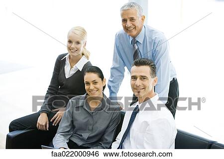 Four business associates smiling at camera, group portrait View Large Photo Image Stock Photograph - Four business associates smiling at camera, group portrait. Fotosearch