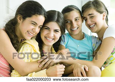 Four young female friends laughing, arms around each other View Large Photo Image Stock Image - Four young female friends laughing, arms around each other. Fotosearch