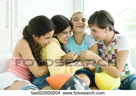 Four young female friends tickling each other and giggling View Large Photo Image Picture - Four young female friends tickling each other and giggling. Fotosearch