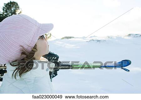 Girl carrying skis on shoulder, looking away, side view View Large Photo Image Stock Photo - Girl carrying skis on shoulder, looking away, side view. Fotosearch