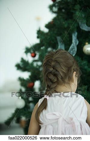 Girl decorating Christmas tree View Large Photo Image Stock Photograph - Girl decorating Christmas tree. Fotosearch