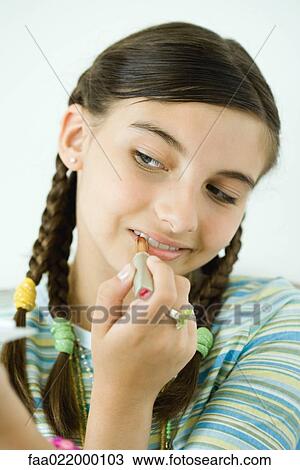 Girl putting on make-up, portrait View Large Photo Image Stock Image - Girl putting on make-up, portrait. Fotosearch