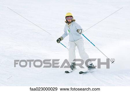 Girl skiing down ski slope, full length View Large Photo Image Stock Photo - Girl skiing down ski slope, full length. Fotosearch
