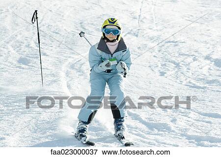Girl skiing down ski slope, full length View Large Photo Image Stock Photo - Girl skiing down ski slope, full length. Fotosearch