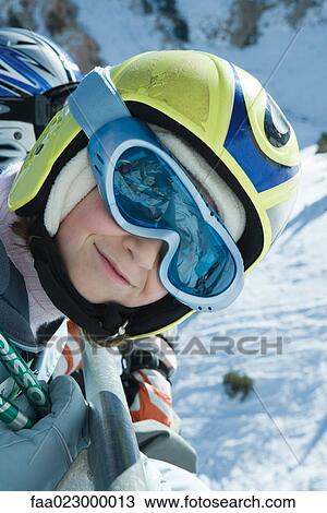 Girl wearing ski goggles and helmet, smiling at camera, portrait View Large Photo Image Stock Image - Girl wearing ski goggles and helmet, smiling at camera, portrait. Fotosearch