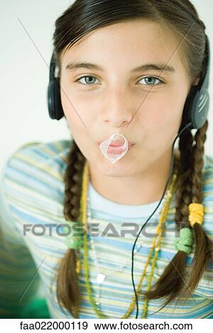 Girl with popped chewing gum bubble on lips, portrait View Large Photo Image Stock Photo - Girl with popped chewing gum bubble on lips, portrait. Fotosearch