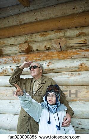Grandfather and grandson standing together, boy pointing, both looking up View Large Photo Image Stock Photography - Grandfather and grandson standing together, boy pointing, both looking up. Fotosearch