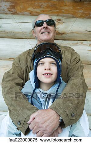 Grandfather embracing grandson, dressed in winter clothing, portrait View Large Photo Image Stock Photography - Grandfather embracing grandson, dressed in winter clothing, portrait. Fotosearch