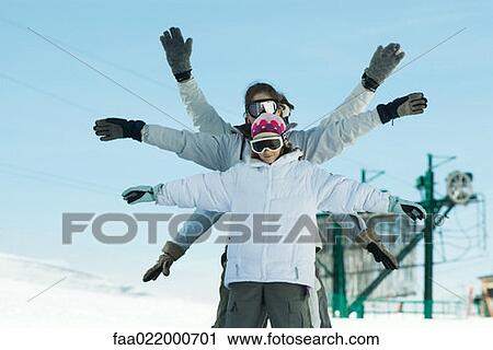 Stock Image - Group having fun in snow, portrait. Fotosearch