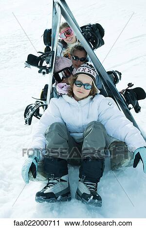 Stock Image - Group of skiers posing under skis in snow, portrait. Fotosearch