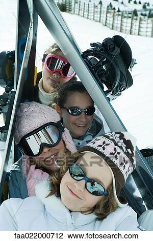 Group of skiers posing under skis in snow, portrait View Large Photo Image Stock Image - Group of skiers posing under skis in snow, portrait. Fotosearch