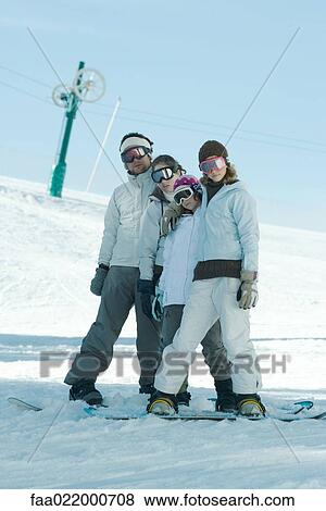 Stock Photo - Group of snowboarders posing in snow, full length. Fotosearch