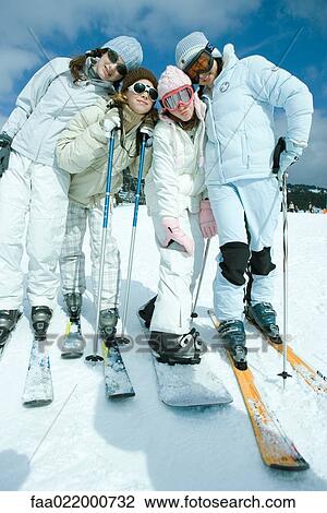 Stock Image - Group of teen girls in ski gear, full length portrait. Fotosearch