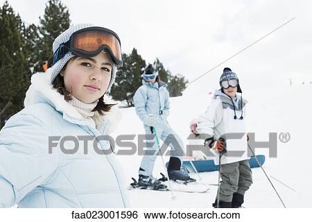 Group of young friends on skis, focus on teen girl in foreground View Large Photo Image Stock Photograph - Group of young friends on skis, focus on teen girl in foreground. Fotosearch