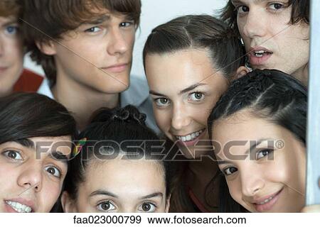 Group of young friends posing for photo, looking at camera, cropped, portrait View Large Photo Image Stock Photo - Group of young friends posing for photo, looking at camera, cropped, portrait. Fotosearch