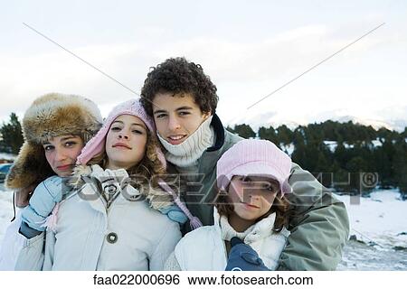 Group of young friends standing in snowy landscape, waist up, portrait View Large Photo Image Stock Photograph - Group of young friends standing in snowy landscape, waist up, portrait. Fotosearch