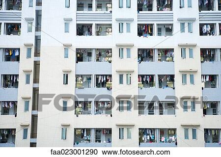 Stock Image - High rise apartment building, laundy hanging out to dry on balconies. Fotosearch