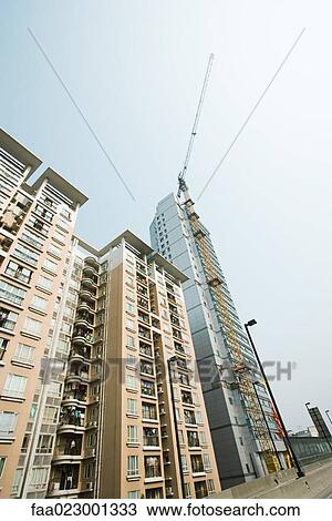 High rises, one under construction, low angle view View Large Photo Image Stock Image - High rises, one under construction, low angle view. Fotosearch