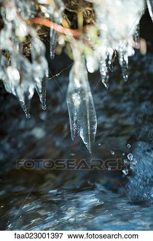 Icicles hanging over stream, extreme close-up View Large Photo Image Stock Photo - Icicles hanging over stream, extreme close-up. Fotosearch