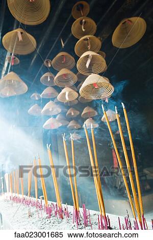 Stock Photography - Incense burning in Chinese temple, low angle view. Fotosearch