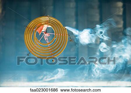 Stock Photograph - Incense burning in Chinese temple, view from directly below. Fotosearch